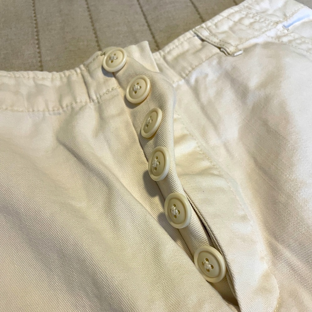 Cream wide leg pants with cargo pockets and multi button front